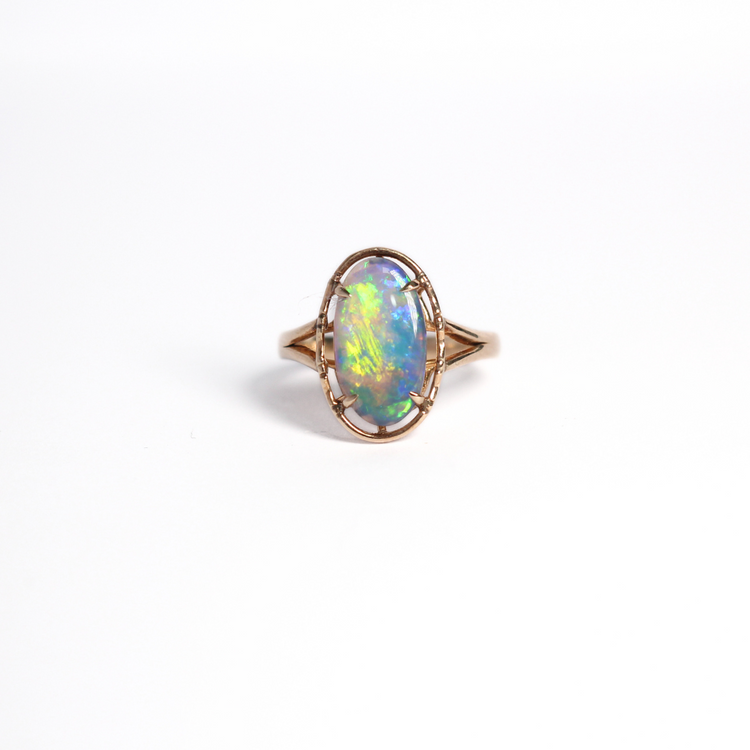 Black opal ring with vivid colours of yellow, green and blue